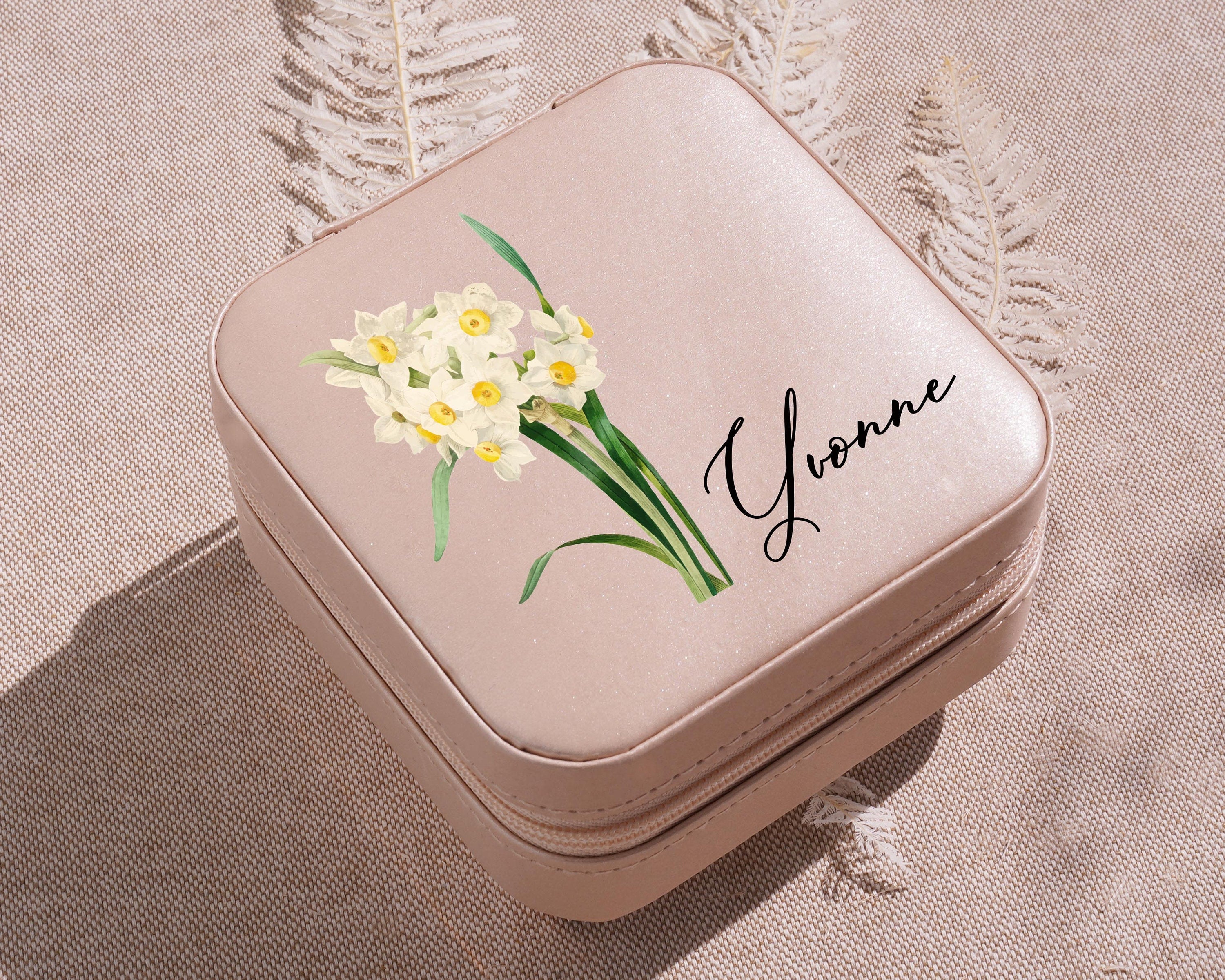 a small pink box with a picture of a daffodils on it