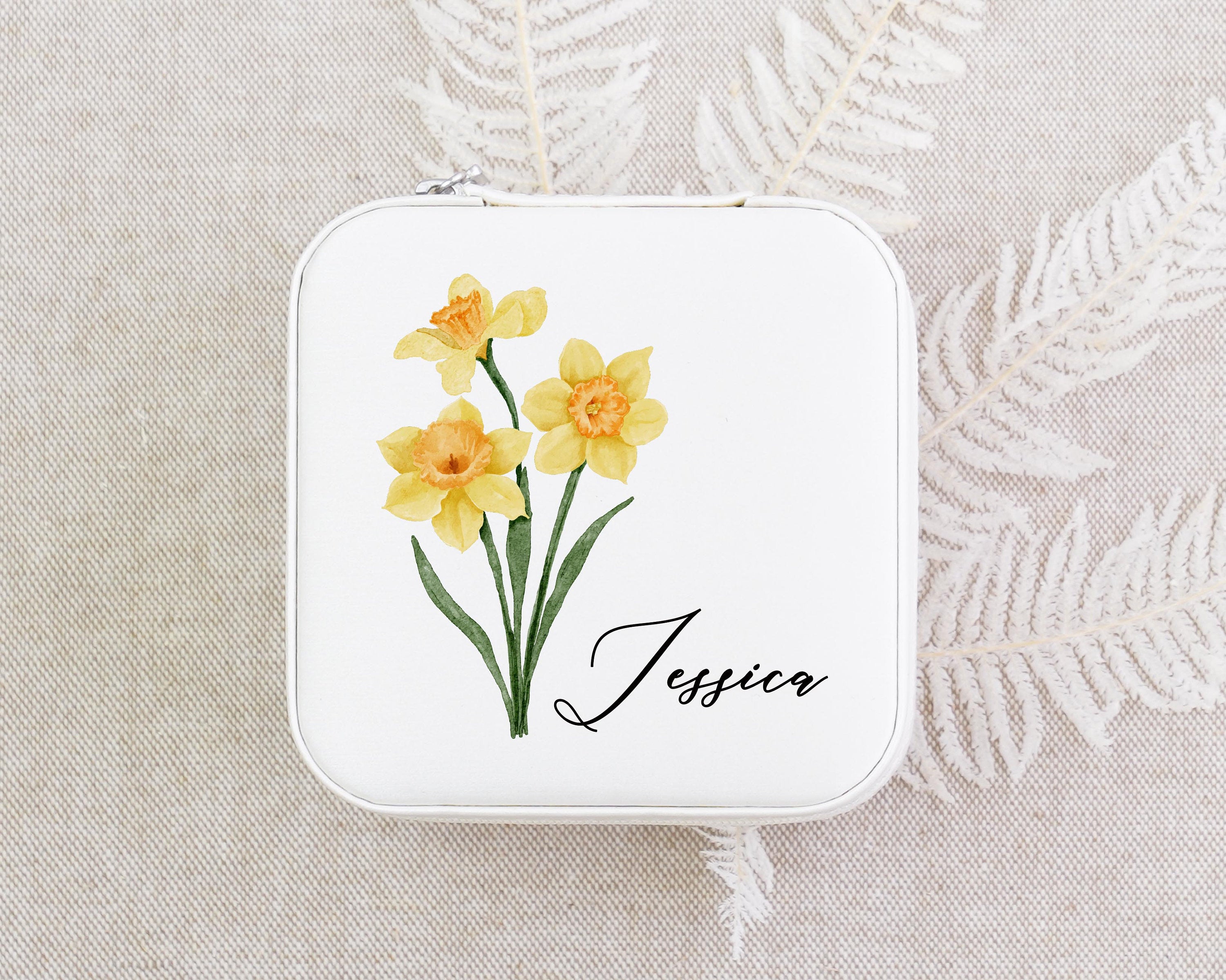 a small tin with some yellow flowers on it