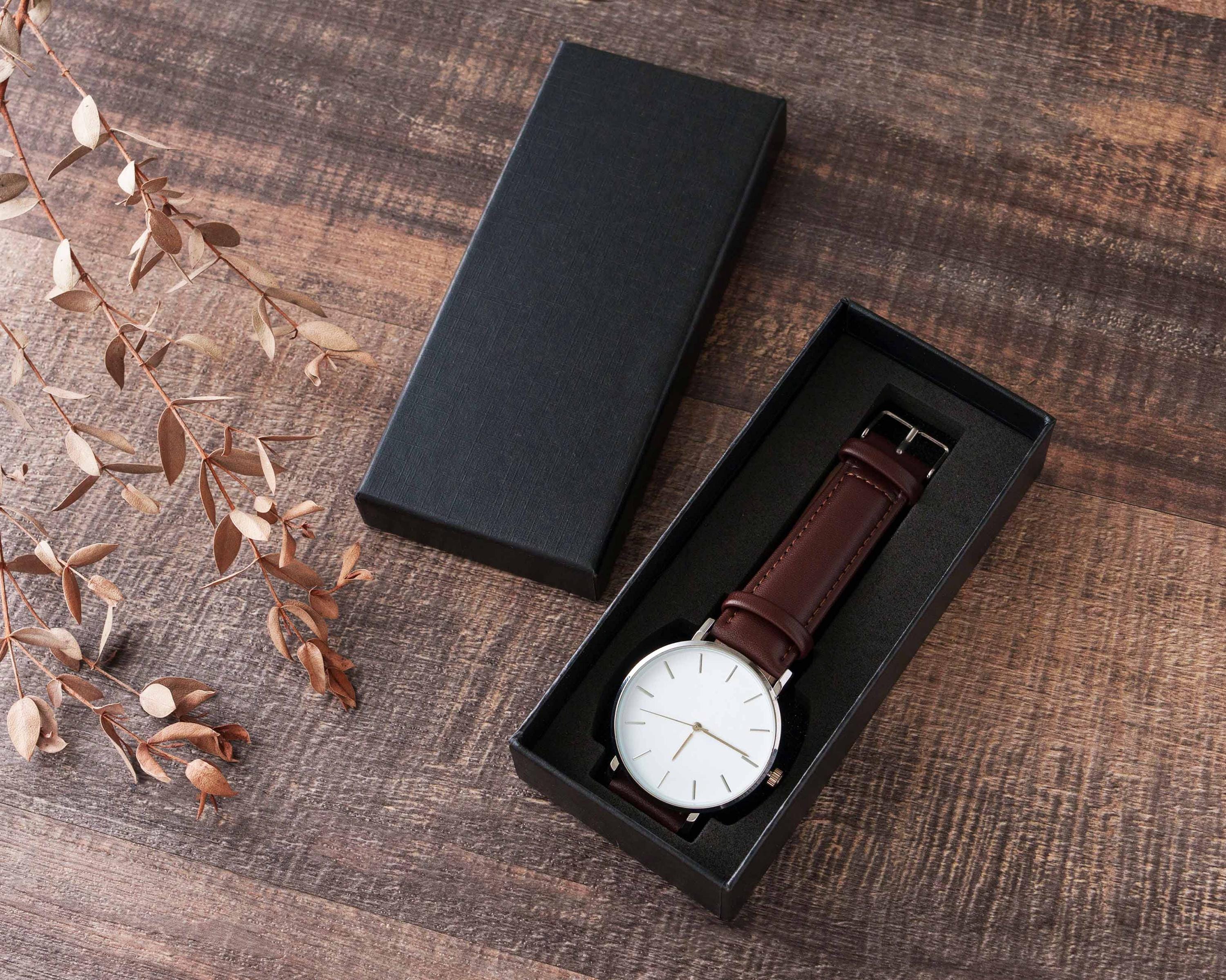 a watch in a box on a wooden table