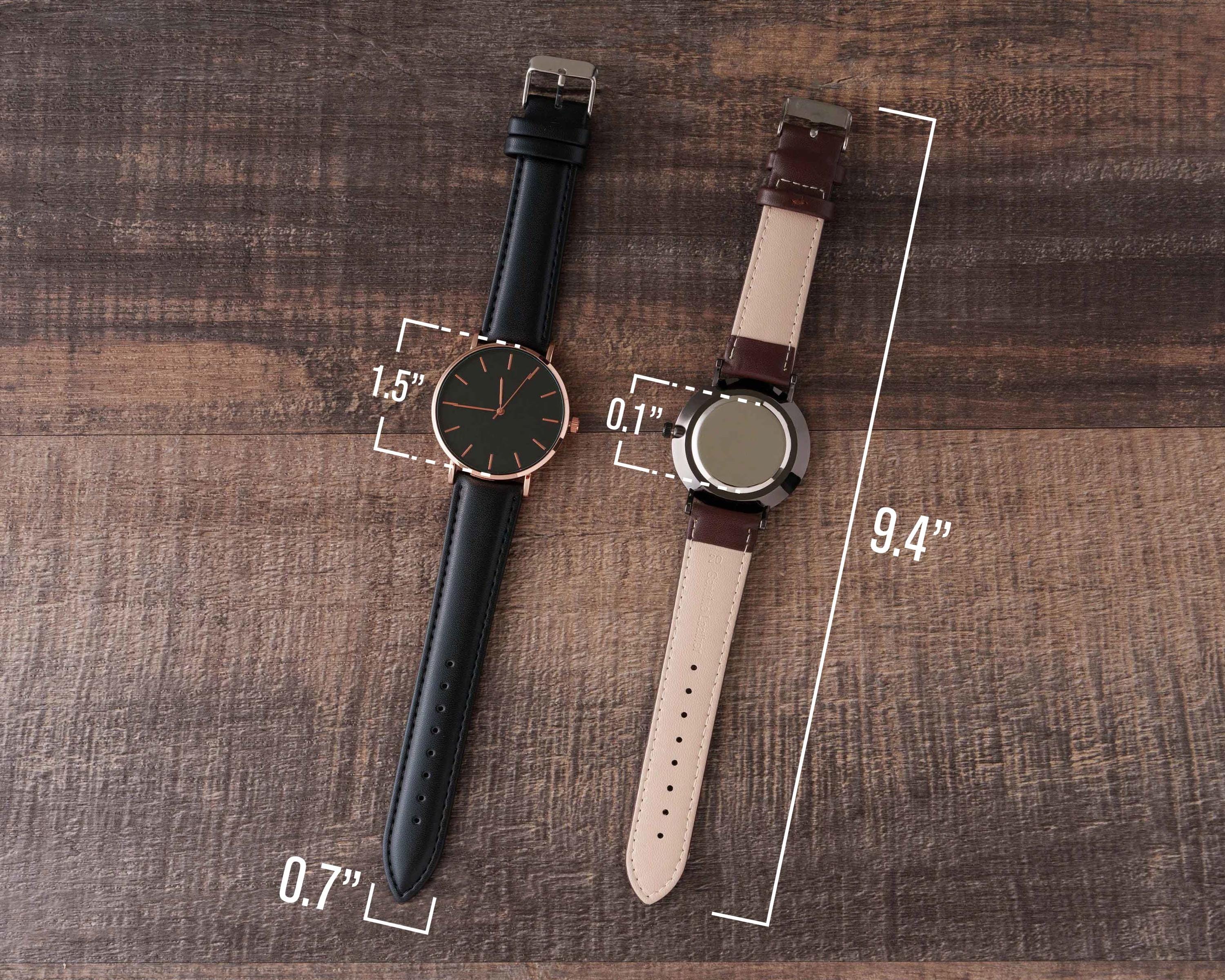 a couple of watches sitting on top of a wooden table