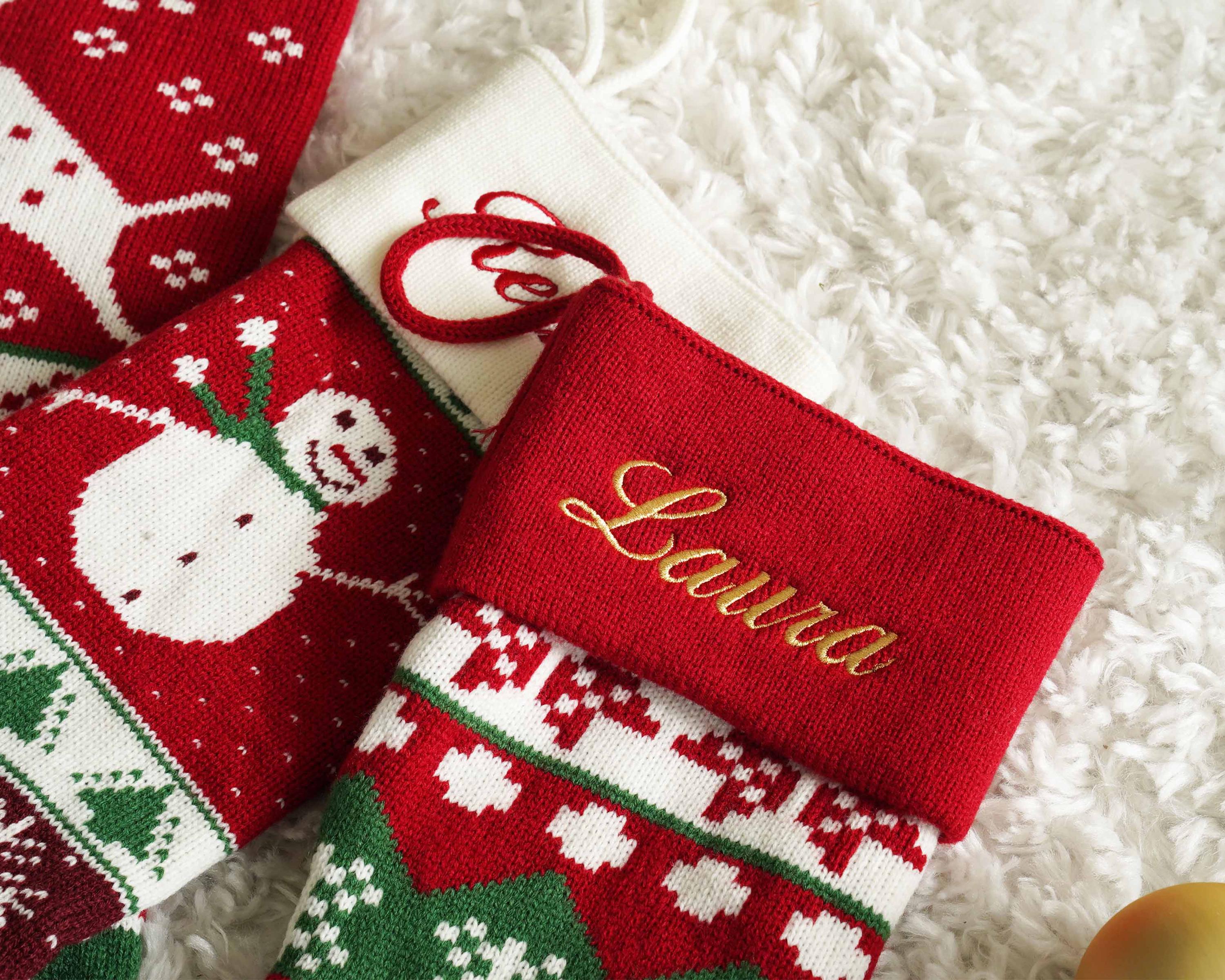 two personalized christmas stockings on a white carpet