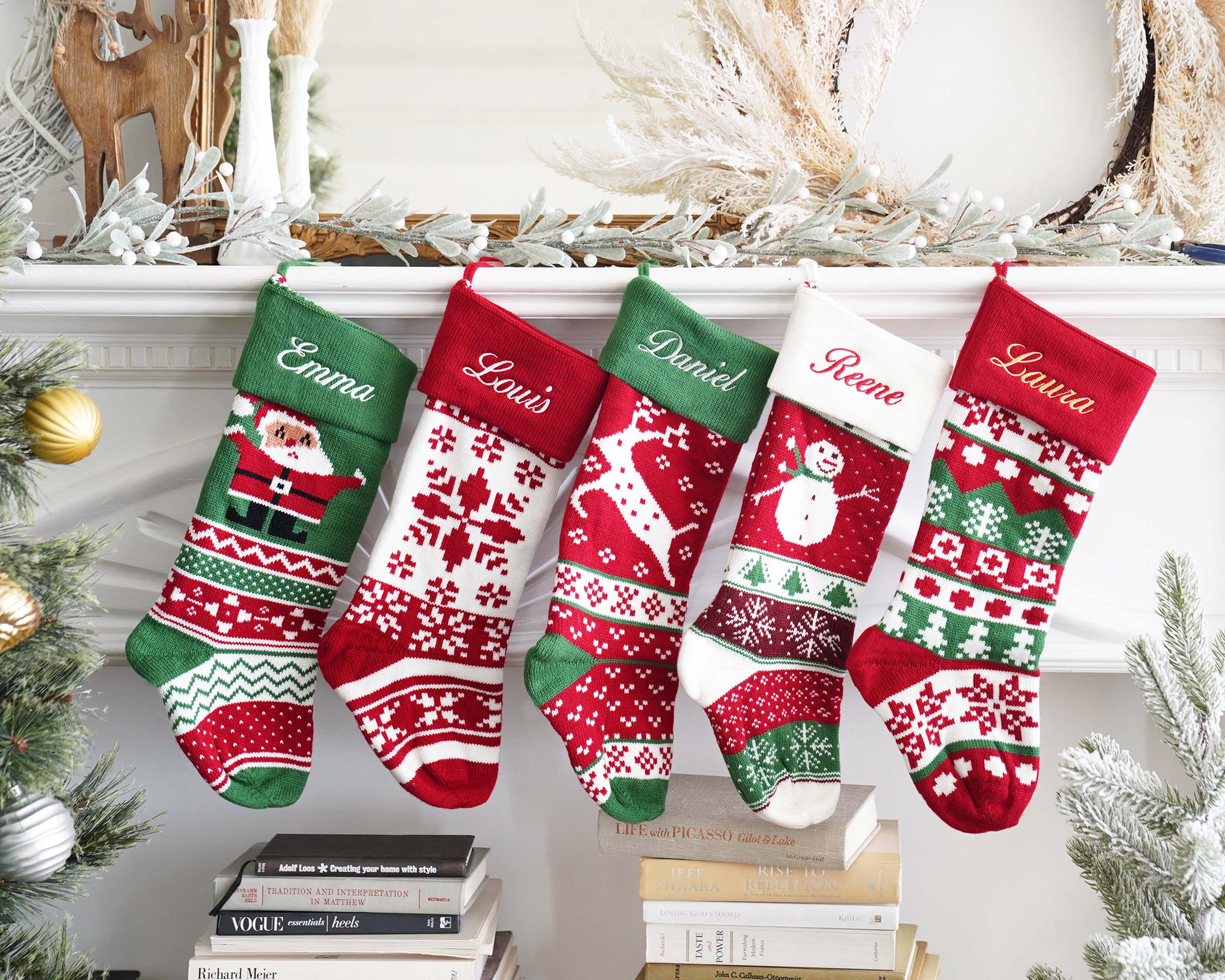 stockings hanging from a mantel decorated with christmas stockings