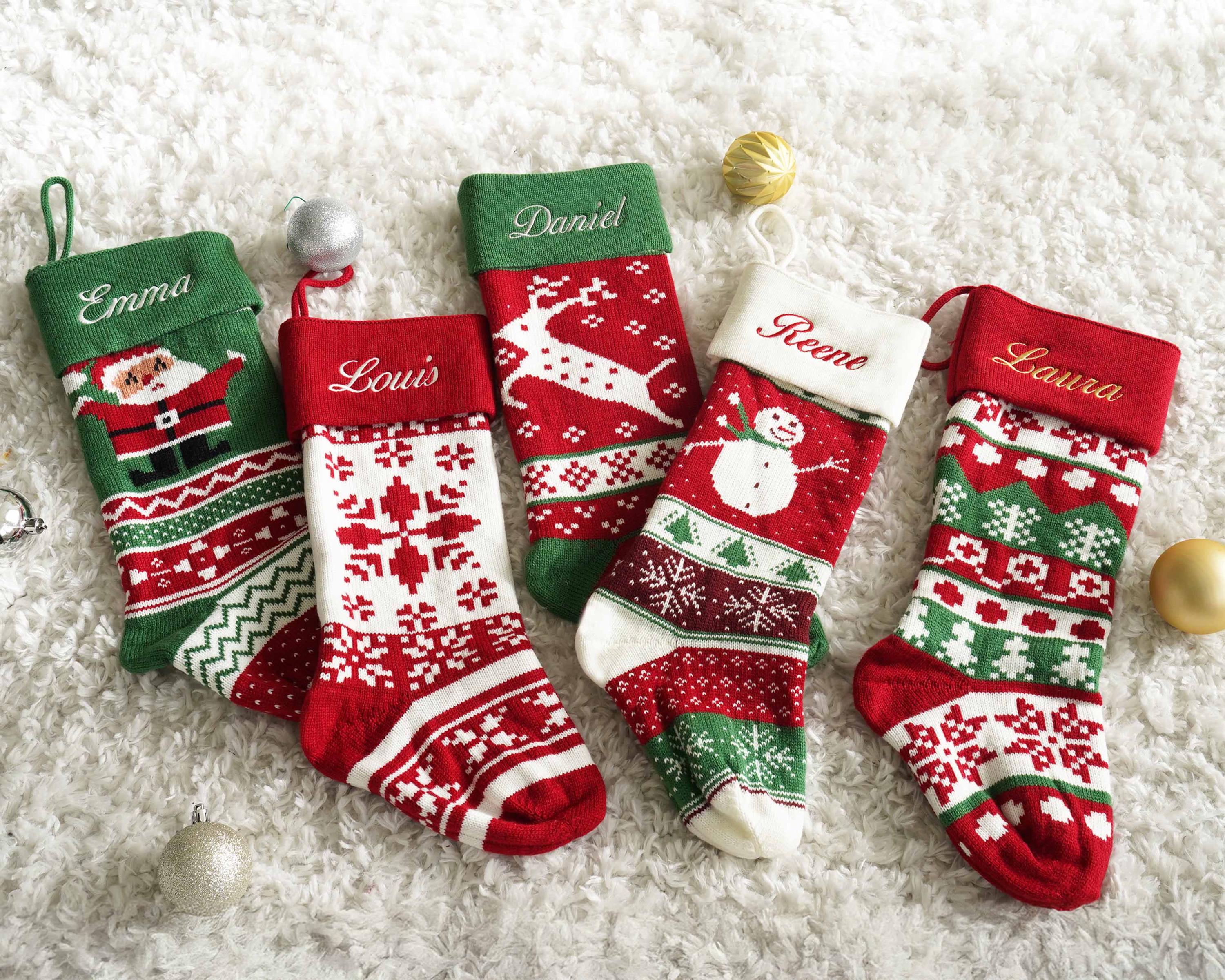 a group of christmas stockings sitting on top of a white carpet