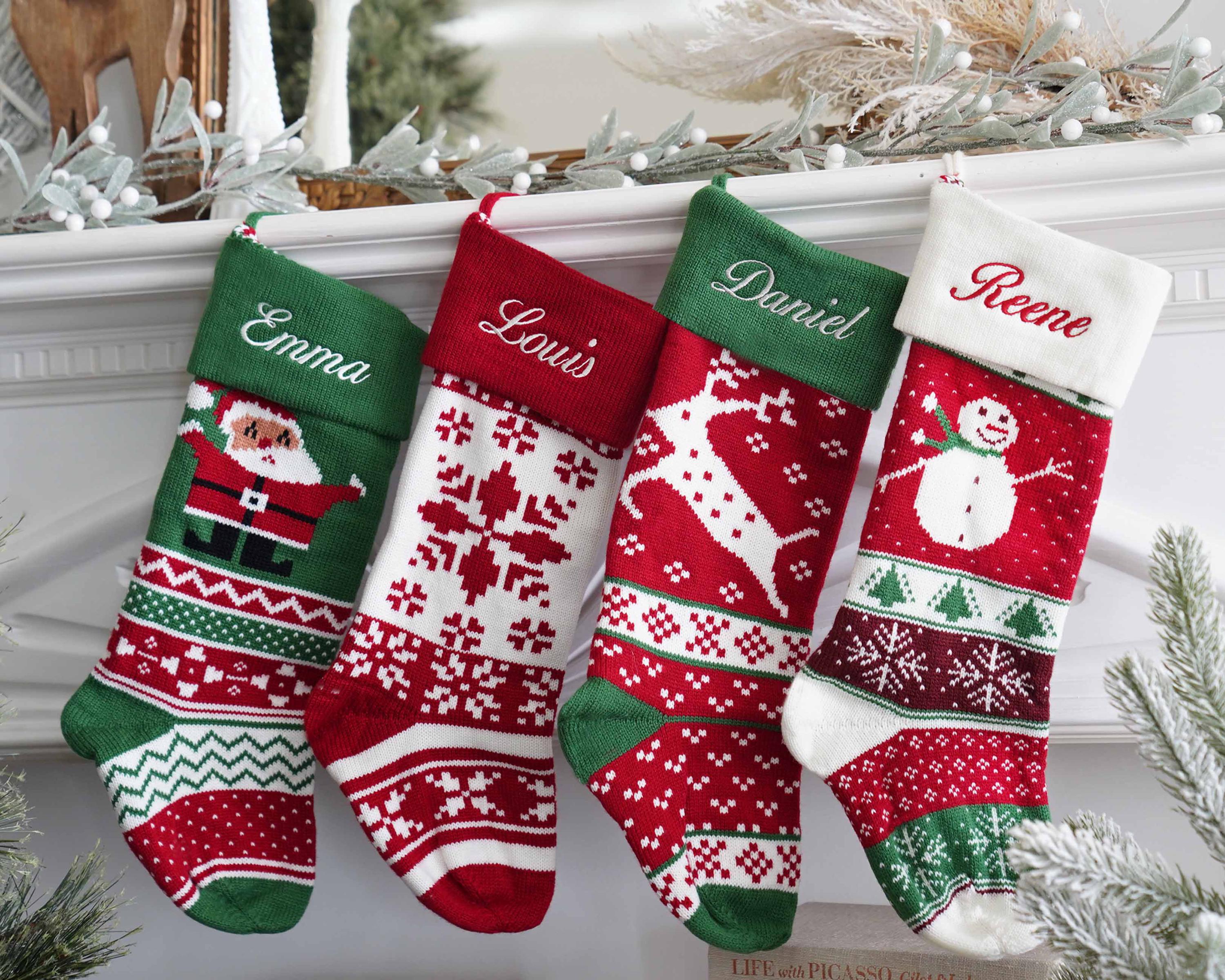 a group of christmas stockings hanging from a mantel